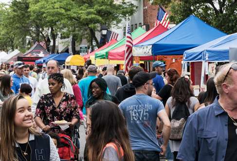 Crowded street festival event with attendees enjoying the event